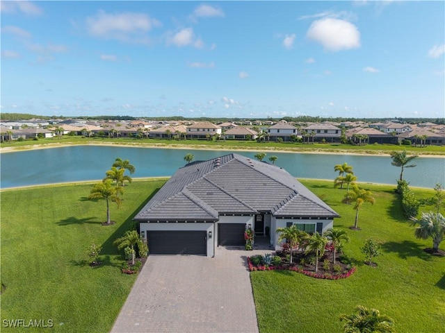 20150 Millrun Dr, Estero, FL 33928 - view of front facade featuring an attached garage, a water view, a residential view, decorative driveway, and a front lawn