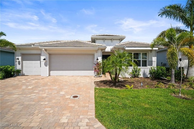 28041 Captiva Shell Loop, Bonita Springs, FL 34135 - prairie-style home featuring an attached garage, decorative driveway, a tiled roof, and a front yard