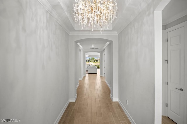28041 Captiva Shell Loop, Bonita Springs, FL 34135 - corridor with arched walkways, wood finished floors, a chandelier, baseboards, and ornamental molding