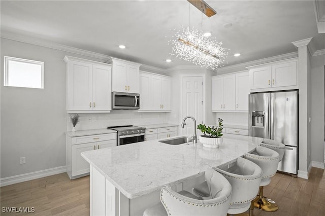 28041 Captiva Shell Loop, Bonita Springs, FL 34135 - kitchen with appliances with stainless steel finishes, a sink, baseboards, white cabinets, and recessed lighting