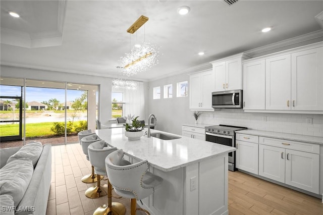 28041 Captiva Shell Loop, Bonita Springs, FL 34135 - kitchen featuring stainless steel appliances, a sink, a chandelier, crown molding, and tasteful backsplash