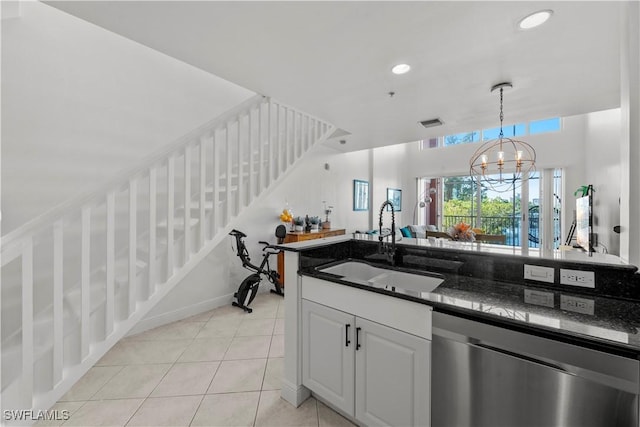 2743 1st St Unit 110, Fort Myers, FL 33916 - kitchen featuring stainless steel dishwasher, a sink, light tile patterned floors, decorative light fixtures, and a chandelier
