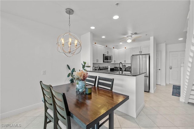 2743 1st St Unit 110, Fort Myers, FL 33916 - dining area with a chandelier, baseboards, light tile patterned flooring, ceiling fan, and recessed lighting