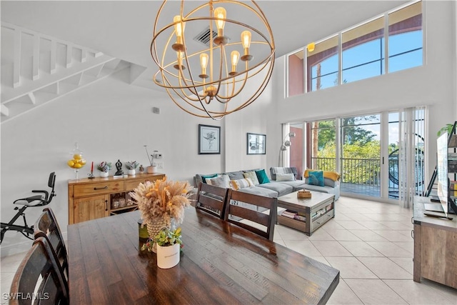 2743 1st St Unit 110, Fort Myers, FL 33916 - dining room featuring a towering ceiling, light tile patterned floors, and a chandelier