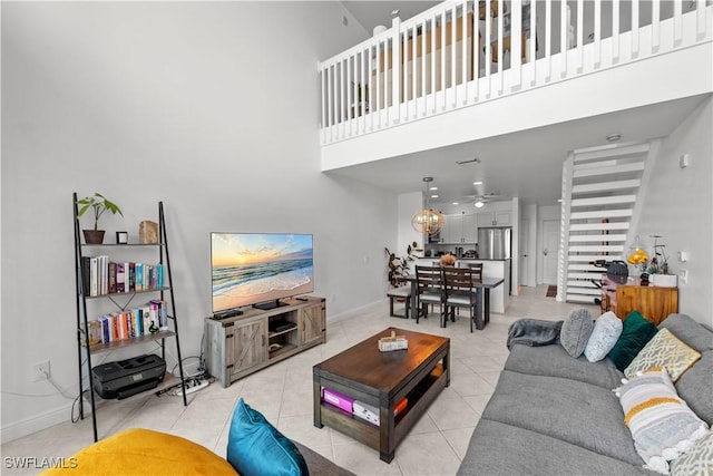 2743 1st St Unit 110, Fort Myers, FL 33916 - living area featuring a high ceiling, light tile patterned floors, baseboards, and ceiling fan