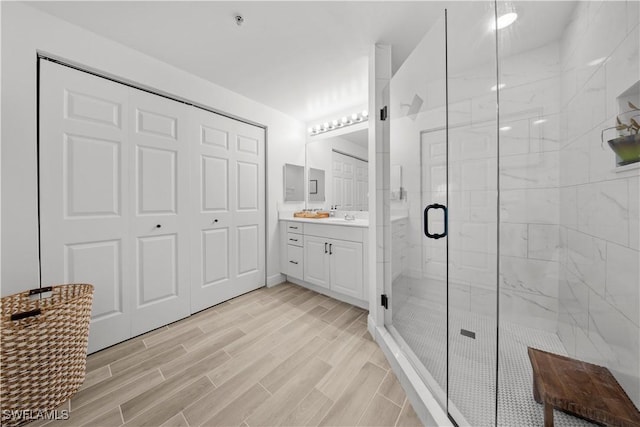 2743 1st St Unit 110, Fort Myers, FL 33916 - bathroom with vanity, a shower stall, and wood finished floors