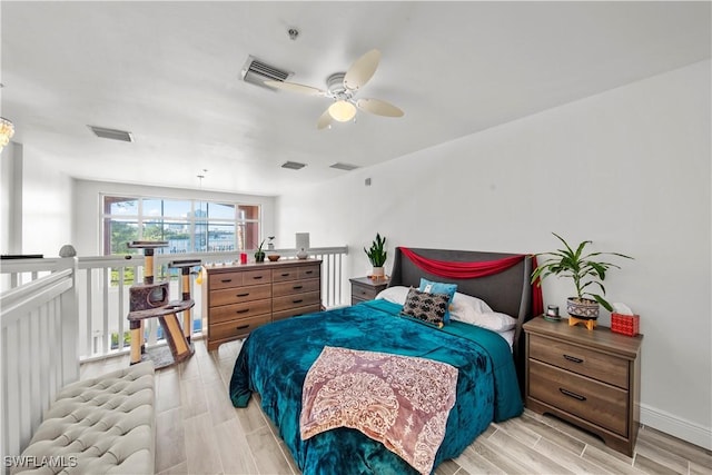 2743 1st St Unit 110, Fort Myers, FL 33916 - bedroom with wood finish floors, a ceiling fan, and baseboards