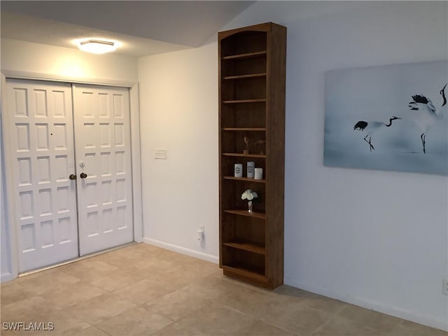 18437 Orangecrest Ct, Lehigh Acres, FL 33936 - foyer with baseboards and light tile patterned flooring