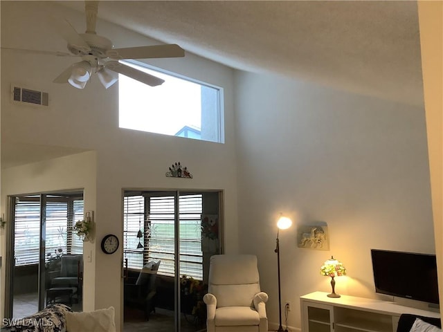 18437 Orangecrest Ct, Lehigh Acres, FL 33936 - living area featuring a towering ceiling, a ceiling fan, and baseboards