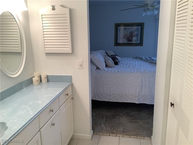 18437 Orangecrest Ct, Lehigh Acres, FL 33936 - bathroom with ensuite bathroom, vanity, tile patterned floors, and baseboards