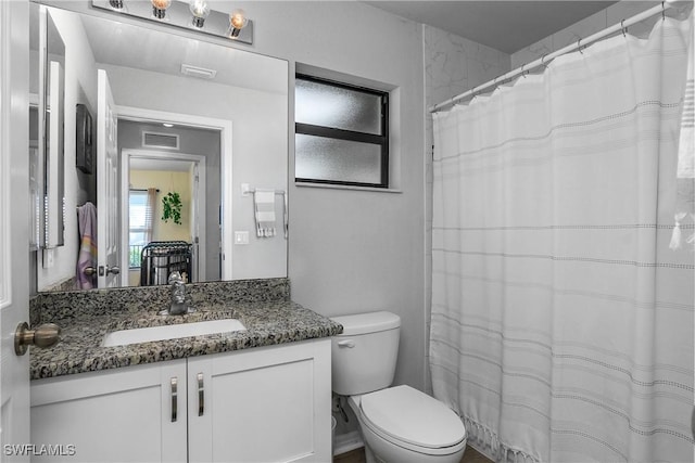 325 NE 24th Ter, Cape Coral, FL 33909 - bathroom with vanity, toilet, and curtained shower