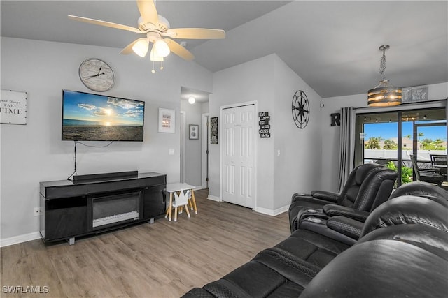 325 NE 24th Ter, Cape Coral, FL 33909 - living room featuring baseboards, lofted ceiling, wood finished floors, and ceiling fan
