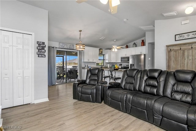 325 NE 24th Ter, Cape Coral, FL 33909 - living room featuring a ceiling fan, vaulted ceiling, and light wood-style flooring