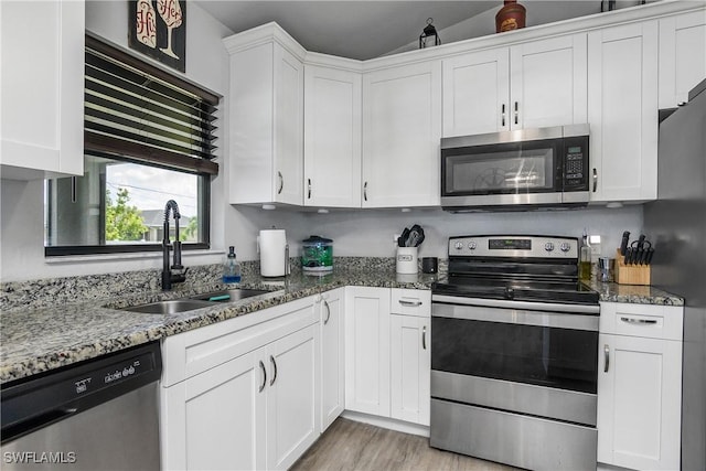 325 NE 24th Ter, Cape Coral, FL 33909 - kitchen featuring appliances with stainless steel finishes, a sink, white cabinets, and lofted ceiling
