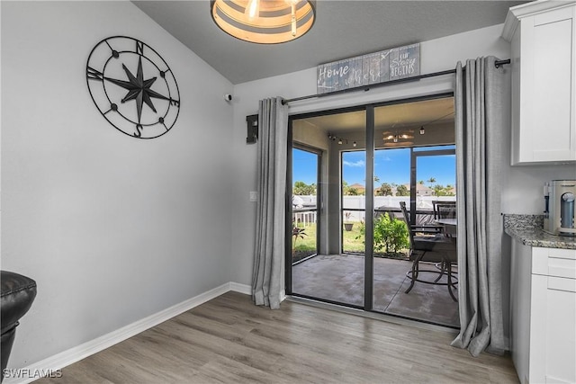 325 NE 24th Ter, Cape Coral, FL 33909 - dining area featuring light wood finished floors, baseboards, and lofted ceiling
