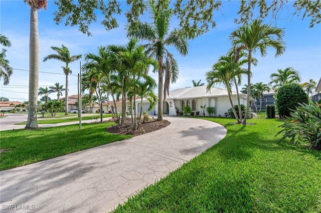 5630 Riverside Dr, Cape Coral, FL 33904 - view of front facade featuring curved driveway and a front yard