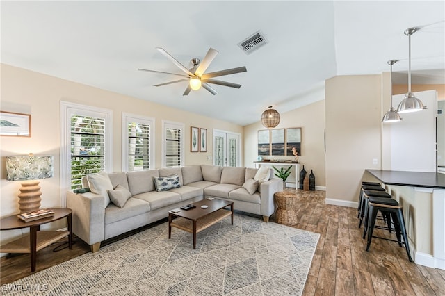 5630 Riverside Dr, Cape Coral, FL 33904 - living area featuring a ceiling fan, wood finished floors, baseboards, and vaulted ceiling