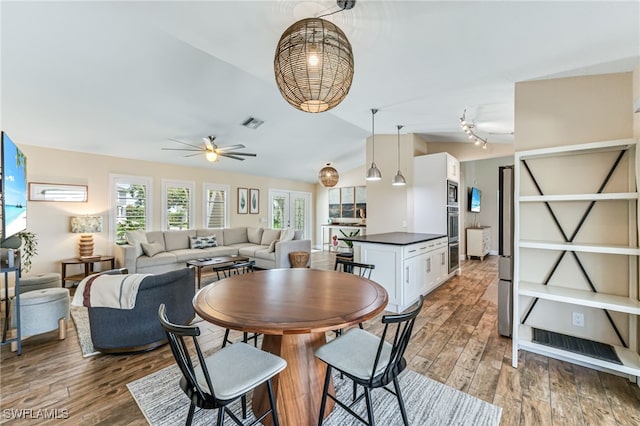 5630 Riverside Dr, Cape Coral, FL 33904 - dining space with healthy amount of natural light, a ceiling fan, light wood finished floors, and lofted ceiling