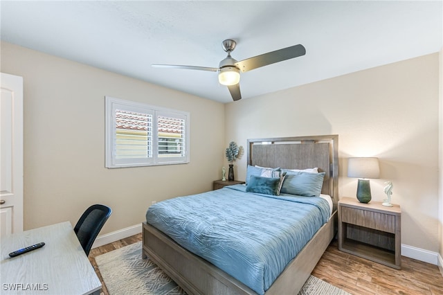 5630 Riverside Dr, Cape Coral, FL 33904 - bedroom with baseboards, wood finished floors, an office area, and ceiling fan