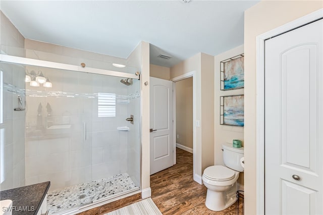 5630 Riverside Dr, Cape Coral, FL 33904 - full bathroom with toilet, a stall shower, wood finished floors, and baseboards