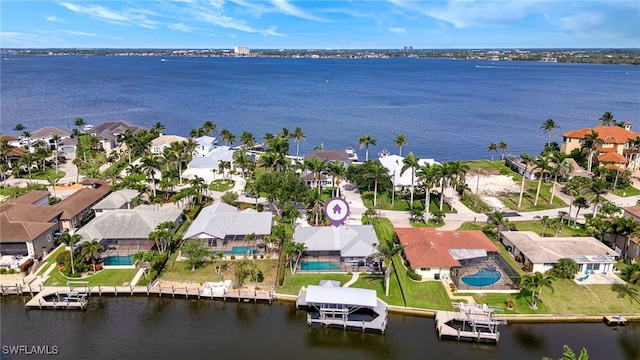 5630 Riverside Dr, Cape Coral, FL 33904 - aerial perspective of suburban area with a nearby body of water and a pool area