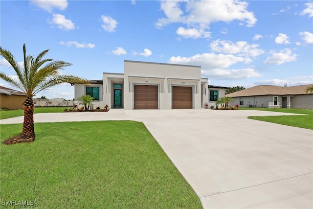 928 NE 8th Place, Cape Coral, FL 33909 - contemporary home with concrete driveway, stucco siding, an attached garage, and a front lawn