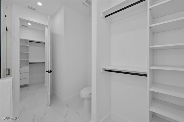 928 NE 8th Place, Cape Coral, FL 33909 - bathroom featuring marble finish flooring, a spacious closet, toilet, recessed lighting, and baseboards