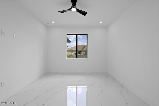 928 NE 8th Place, Cape Coral, FL 33909 - spare room featuring baseboards, marble finish flooring, recessed lighting, and a ceiling fan