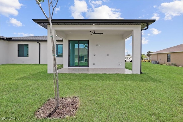 928 NE 8th Place, Cape Coral, FL 33909 - back of property with a patio area, stucco siding, a ceiling fan, central AC unit, and a lawn