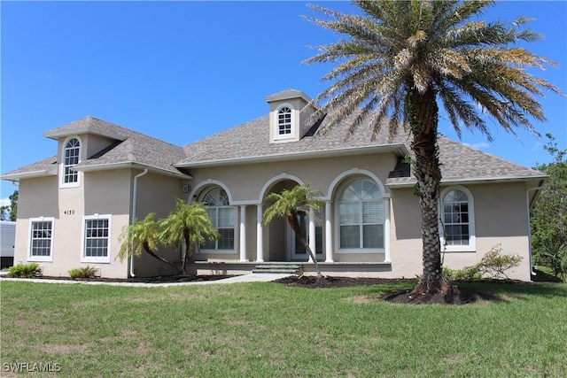 4150 Enclave Pl, Punta Gorda, FL 33980 - view of front facade with stucco siding, a front yard, and roof with shingles