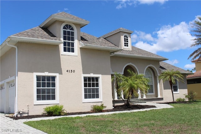 4150 Enclave Pl, Punta Gorda, FL 33980 - view of front facade with stucco siding, a front lawn, and a shingled roof