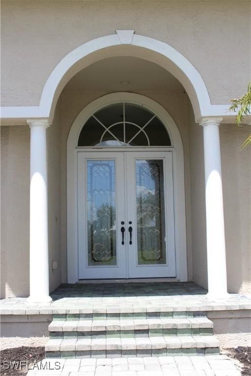 4150 Enclave Pl, Punta Gorda, FL 33980 - entrance to property with french doors and stucco siding
