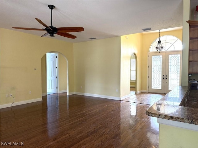 4150 Enclave Pl, Punta Gorda, FL 33980 - entryway with arched walkways, wood finished floors, a ceiling fan, french doors, and baseboards
