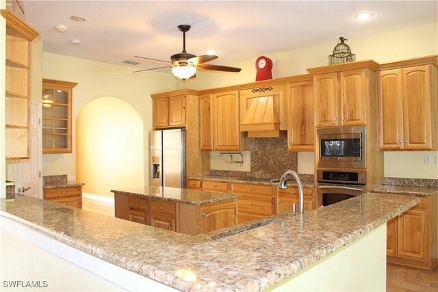 4150 Enclave Pl, Punta Gorda, FL 33980 - kitchen with appliances with stainless steel finishes, a sink, custom exhaust hood, a kitchen island, and a ceiling fan