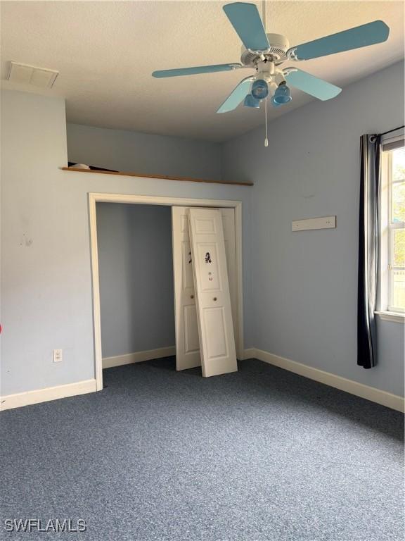 4150 Enclave Pl, Punta Gorda, FL 33980 - unfurnished bedroom with carpet, baseboards, ceiling fan, and a closet