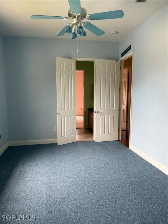 4150 Enclave Pl, Punta Gorda, FL 33980 - unfurnished bedroom with baseboards, carpet flooring, and ceiling fan