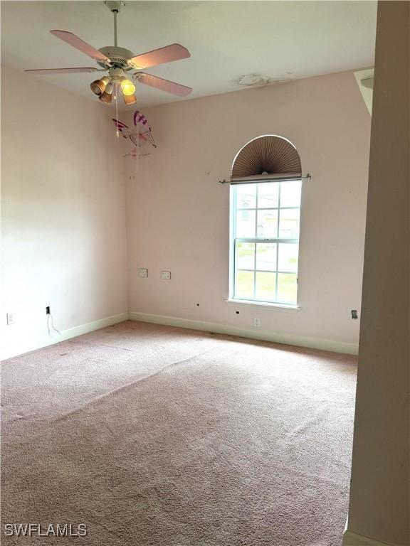4150 Enclave Pl, Punta Gorda, FL 33980 - empty room with carpet floors, ceiling fan, and baseboards