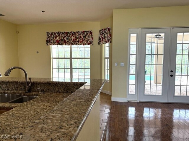 4150 Enclave Pl, Punta Gorda, FL 33980 - kitchen with french doors, dark wood-style floors, and baseboards