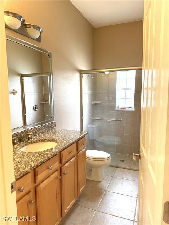 4150 Enclave Pl, Punta Gorda, FL 33980 - full bath with tile patterned floors, toilet, vanity, and a tile shower