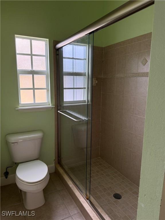 4150 Enclave Pl, Punta Gorda, FL 33980 - bathroom with tile patterned flooring, toilet, and a shower stall
