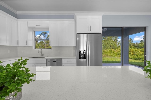 570 Sherwood Ave S, Lehigh Acres, FL 33974 - kitchen featuring stainless steel appliances, a sink, light stone countertops, white cabinets, and crown molding