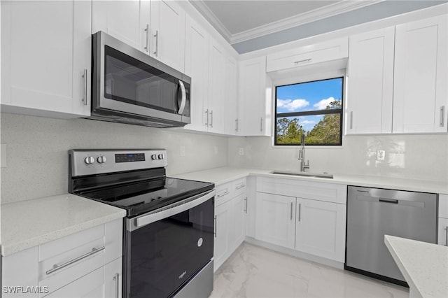 570 Sherwood Ave S, Lehigh Acres, FL 33974 - kitchen with stainless steel appliances, a sink, light marble finish floors, crown molding, and white cabinetry