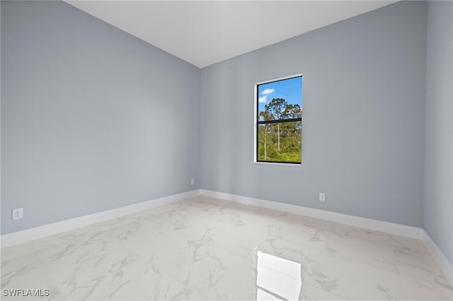 570 Sherwood Ave S, Lehigh Acres, FL 33974 - empty room featuring light marble finish flooring and baseboards