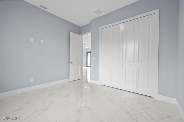 570 Sherwood Ave S, Lehigh Acres, FL 33974 - unfurnished bedroom with marble look tiles and baseboards