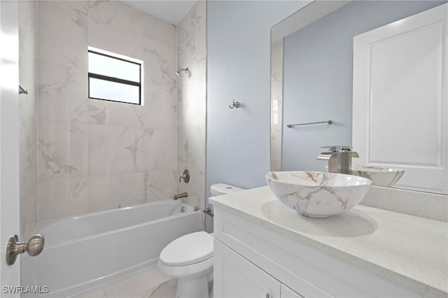 570 Sherwood Ave S, Lehigh Acres, FL 33974 - full bathroom with vanity, toilet,  shower combination, and marble look tiles