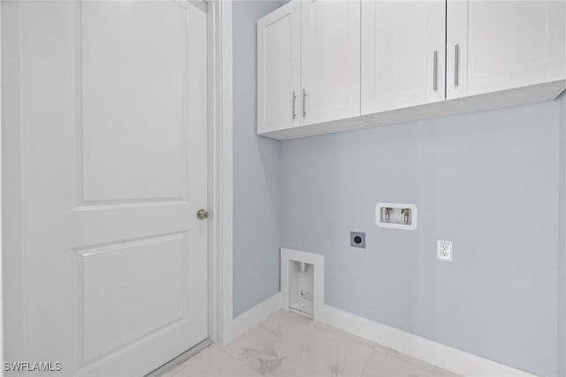 570 Sherwood Ave S, Lehigh Acres, FL 33974 - laundry area with hookup for an electric dryer, washer hookup, cabinet space, light marble finish floors, and baseboards