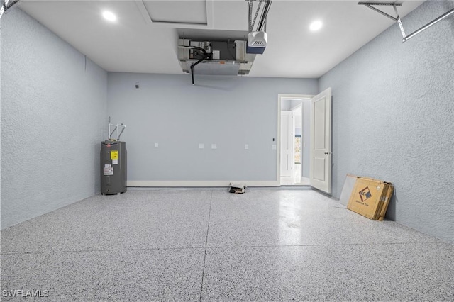 570 Sherwood Ave S, Lehigh Acres, FL 33974 - garage featuring water heater, a garage door opener, a textured wall, and recessed lighting