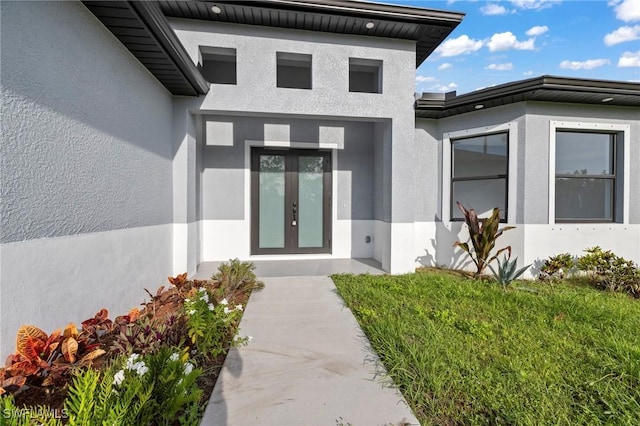 570 Sherwood Ave S, Lehigh Acres, FL 33974 - property entrance with stucco siding and french doors