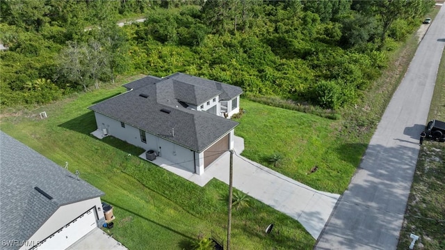 570 Sherwood Ave S, Lehigh Acres, FL 33974 - view from above of property featuring a heavily wooded area
