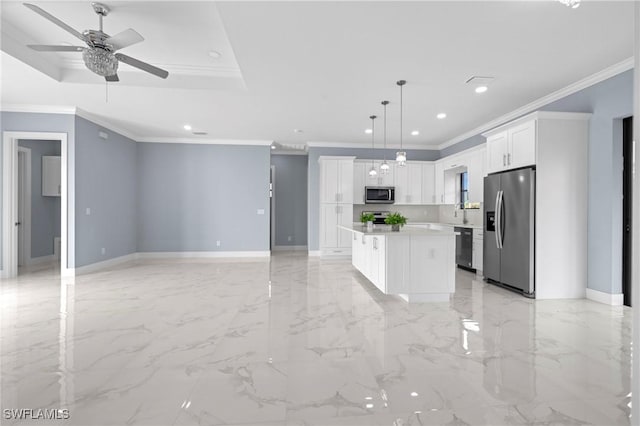 570 Sherwood Ave S, Lehigh Acres, FL 33974 - kitchen featuring stainless steel appliances, a ceiling fan, a center island, crown molding, and white cabinets